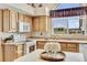 Close-up on a lovely kitchen showcasing wooden cabinetry and an abundance of natural light at 5129 S Tom Bay Rd, Bennett, CO 80102