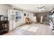 Spacious living area with tiled flooring, ceiling fan and access to the exterior at 5129 S Tom Bay Rd, Bennett, CO 80102