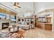 Spacious living room featuring a cozy fireplace and an open layout to the kitchen at 5129 S Tom Bay Rd, Bennett, CO 80102