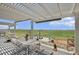 Relaxing outdoor space with pergola, dining area, fountain, and open views at 5129 S Tom Bay Rd, Bennett, CO 80102
