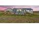 The back exterior shows a well-manicured lawn and seating space with pergola at 5129 S Tom Bay Rd, Bennett, CO 80102