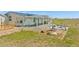Backyard view with pergola covered patio, an outdoor grill, fountain, and seating at 5129 S Tom Bay Rd, Bennett, CO 80102