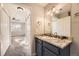 Bathroom with granite countertop vanity and view into bedroom with large window at 22520 E Ontario Dr # 101, Aurora, CO 80016