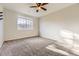 Bedroom featuring neutral carpet, ceiling fan, and window with natural light at 22520 E Ontario Dr # 101, Aurora, CO 80016