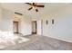 Carpeted bedroom with open doorway to bath and neutral color palette at 22520 E Ontario Dr # 101, Aurora, CO 80016