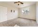 Bedroom with carpeted floors, ceiling fan, and large window at 22520 E Ontario Dr # 101, Aurora, CO 80016