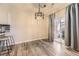 Sunlit dining area with hardwood floors and sliding glass door at 22520 E Ontario Dr # 101, Aurora, CO 80016