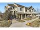 Charming townhouse featuring a stucco facade, tiled roof, and inviting front entrance with stone accents at 22520 E Ontario Dr # 101, Aurora, CO 80016