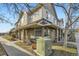 View of a stucco-clad townhouse with stone accents and a tiled roof, nestled within a residential neighborhood at 22520 E Ontario Dr # 101, Aurora, CO 80016