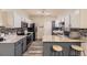 Well-lit kitchen boasts stainless appliances, granite countertops, and adjacent breakfast bar at 22520 E Ontario Dr # 101, Aurora, CO 80016