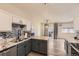 Well-lit kitchen featuring modern appliances, granite countertops, and an open view into the adjacent living area at 22520 E Ontario Dr # 101, Aurora, CO 80016