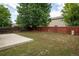 Extensive backyard area with a concrete patio, ample lawn, and a wooden fence at 5225 E 100Th Dr, Thornton, CO 80229