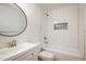 Stylish bathroom with white subway tile, a bathtub, and a sleek round mirror at 5225 E 100Th Dr, Thornton, CO 80229