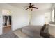 Bright bedroom features a ceiling fan, plush carpet, and a large walk-in closet for ample storage at 5225 E 100Th Dr, Thornton, CO 80229