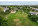Aerial view of a community park featuring a playground, soccer field, and mature trees at 5225 E 100Th Dr, Thornton, CO 80229