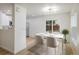 Contemporary dining area with hardwood floors, natural light, modern table, and view of kitchen at 5225 E 100Th Dr, Thornton, CO 80229