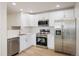 Modern kitchen featuring stainless steel appliances, white cabinetry, and quartz countertops at 5225 E 100Th Dr, Thornton, CO 80229