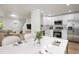 Modern kitchen featuring stainless steel appliances, white cabinetry, and an open layout to the dining area at 5225 E 100Th Dr, Thornton, CO 80229