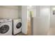 Efficient laundry room features a washer, dryer, and overhead shelving for organized storage at 5225 E 100Th Dr, Thornton, CO 80229