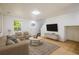 Inviting living room featuring neutral tones, hardwood floors, comfortable seating, and natural light at 5225 E 100Th Dr, Thornton, CO 80229
