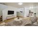 Bright living room with modern furniture, light hardwood floors, and access to the dining room at 5225 E 100Th Dr, Thornton, CO 80229
