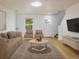 Inviting living room with neutral tones, hardwood floors, comfortable seating, and access to entry door at 5225 E 100Th Dr, Thornton, CO 80229