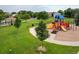 Community playground with colorful play equipment and lush green surroundings at 5225 E 100Th Dr, Thornton, CO 80229