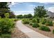 Picturesque walkway lined with lush greenery and river rock in a common area at 5225 E 100Th Dr, Thornton, CO 80229
