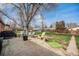 Spacious backyard with patio, mature tree, and well-maintained lawn at 3937 W Grand Ave, Littleton, CO 80123