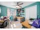 Bedroom featuring blue walls, two desks and overhead storage shelving at 3937 W Grand Ave, Littleton, CO 80123