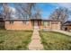 Charming brick home with a well-maintained lawn and attached garage at 3937 W Grand Ave, Littleton, CO 80123