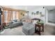 Comfortable living room with a gray sectional sofa and neutral carpet at 3937 W Grand Ave, Littleton, CO 80123