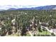 Aerial view of wooded acreage with a residence and private drive at 4456 Mohawk Dr, Larkspur, CO 80118