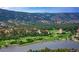 Expansive aerial view showcasing the community's golf course and lake at 4456 Mohawk Dr, Larkspur, CO 80118