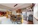 Basement bar with seating, rustic design elements, lighting, and kitchen appliances at 4456 Mohawk Dr, Larkspur, CO 80118