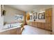 Luxurious bathroom with a soaking tub, double vanity, and stylish tile flooring, creating a serene retreat at 4456 Mohawk Dr, Larkspur, CO 80118
