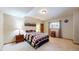 Bedroom with neutral colored walls, carpeted floor, natural light, and mountain themed decor at 4456 Mohawk Dr, Larkspur, CO 80118