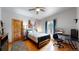 Bedroom featuring hardwood floors, natural light, and a dark wood bed frame at 4456 Mohawk Dr, Larkspur, CO 80118