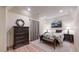 Cozy bedroom with dark wood furniture, tray ceiling and decorative art at 4456 Mohawk Dr, Larkspur, CO 80118