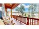Charming deck with rustic chairs, offering views of the home and surrounding greenery at 4456 Mohawk Dr, Larkspur, CO 80118