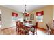Cozy dining room with a wooden table set, complemented by natural light streaming through the adjacent windows at 4456 Mohawk Dr, Larkspur, CO 80118