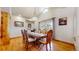Bright dining room featuring a beautiful wood table, chandelier, and ample natural light from large windows at 4456 Mohawk Dr, Larkspur, CO 80118
