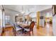 Elegant dining area with hardwood floors, vaulted ceilings, and natural wood accents creates a warm atmosphere at 4456 Mohawk Dr, Larkspur, CO 80118