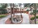 Elegant home featuring a spacious front porch, stone accents, meticulous landscaping, and decorative waterfall at 4456 Mohawk Dr, Larkspur, CO 80118