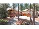 Gorgeous home with stone details, a wrap-around deck, and mature trees at 4456 Mohawk Dr, Larkspur, CO 80118
