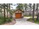 Single car detached garage with carriage doors and stone accents at 4456 Mohawk Dr, Larkspur, CO 80118