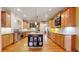 Spacious kitchen featuring custom cabinets, modern appliances, and a central island, perfect for cooking at 4456 Mohawk Dr, Larkspur, CO 80118