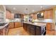 Gourmet kitchen with custom cabinets, granite counters, stainless steel appliances, and a large center island at 4456 Mohawk Dr, Larkspur, CO 80118