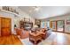 Bright living room with vaulted ceiling, stone fireplace, and access to the outdoor patio at 4456 Mohawk Dr, Larkspur, CO 80118