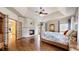 Comfortable main bedroom featuring a cozy fireplace, hardwood floors, and ample natural light from multiple windows at 4456 Mohawk Dr, Larkspur, CO 80118